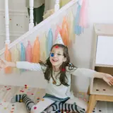 Children On Staircase Shower Confetti On Girl Below Wearing A Party Hat